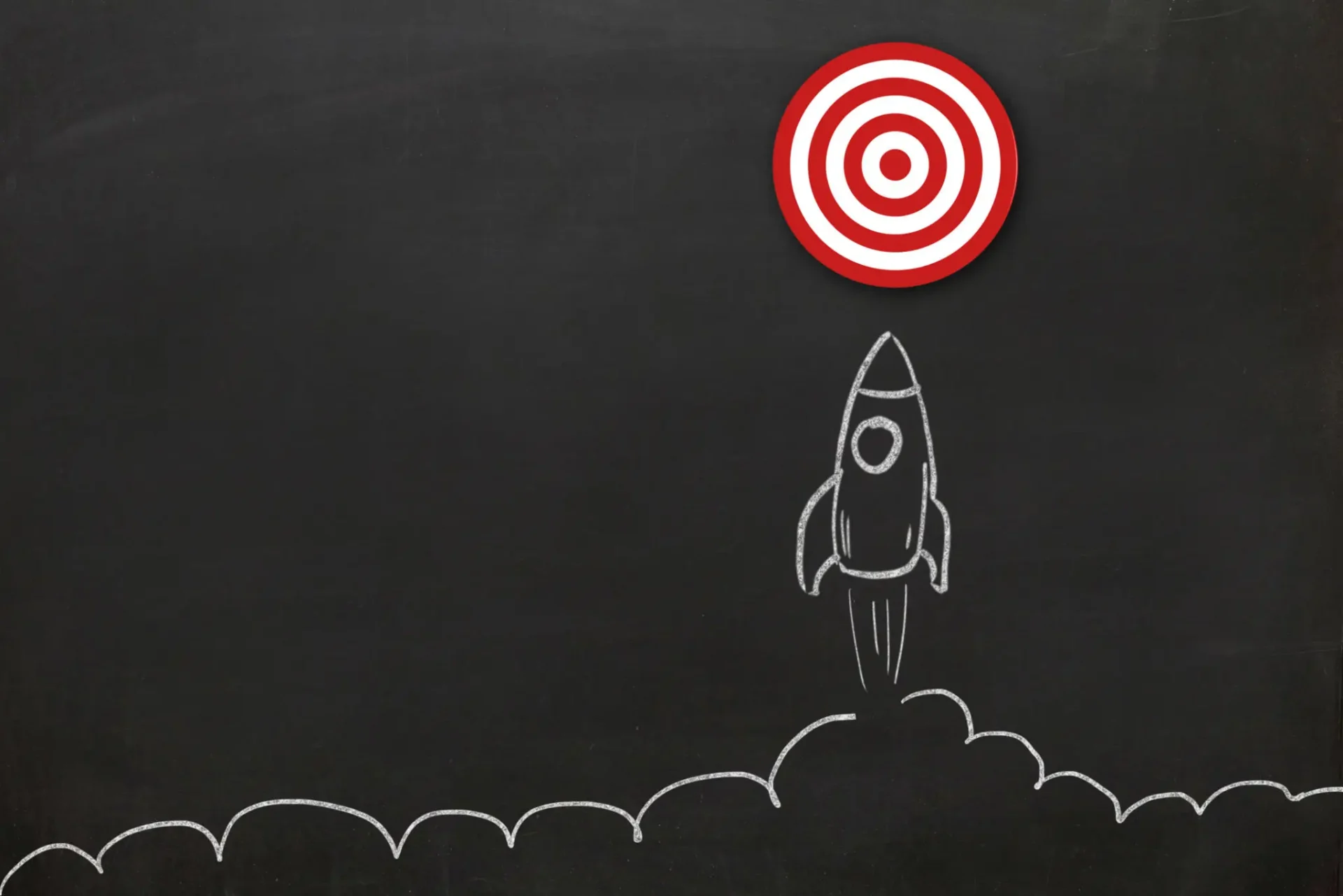 Chalkboard rocket launching toward red bullseye target